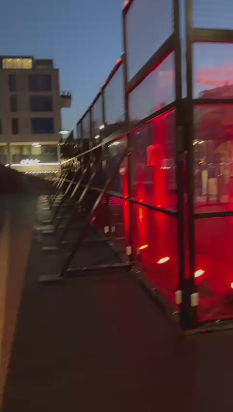 Modern event venue setup with illuminated red lights in Copenhagen at dusk.